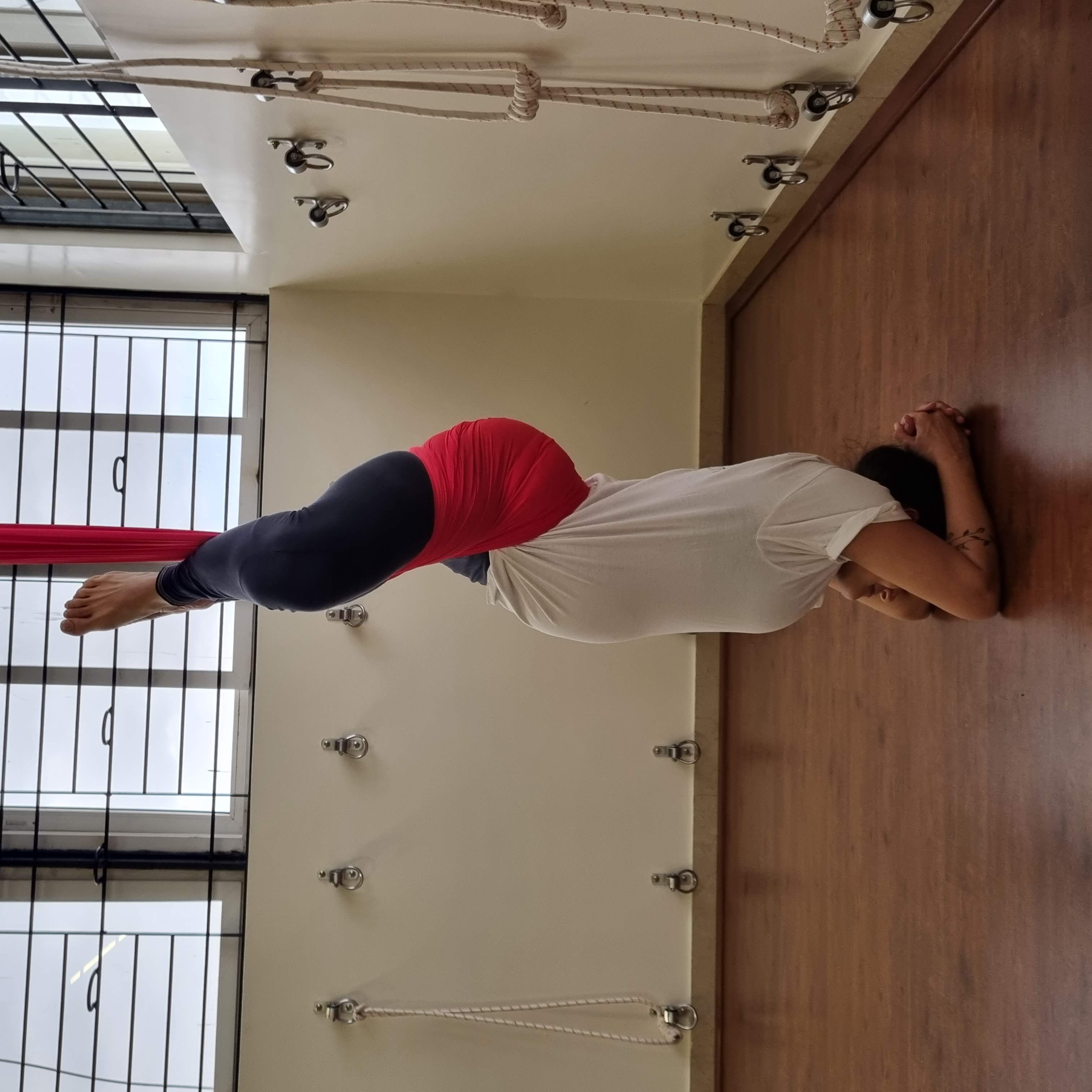 I practiced supported inversions during pregnancy, such as this sirsasana using an aerial rope.